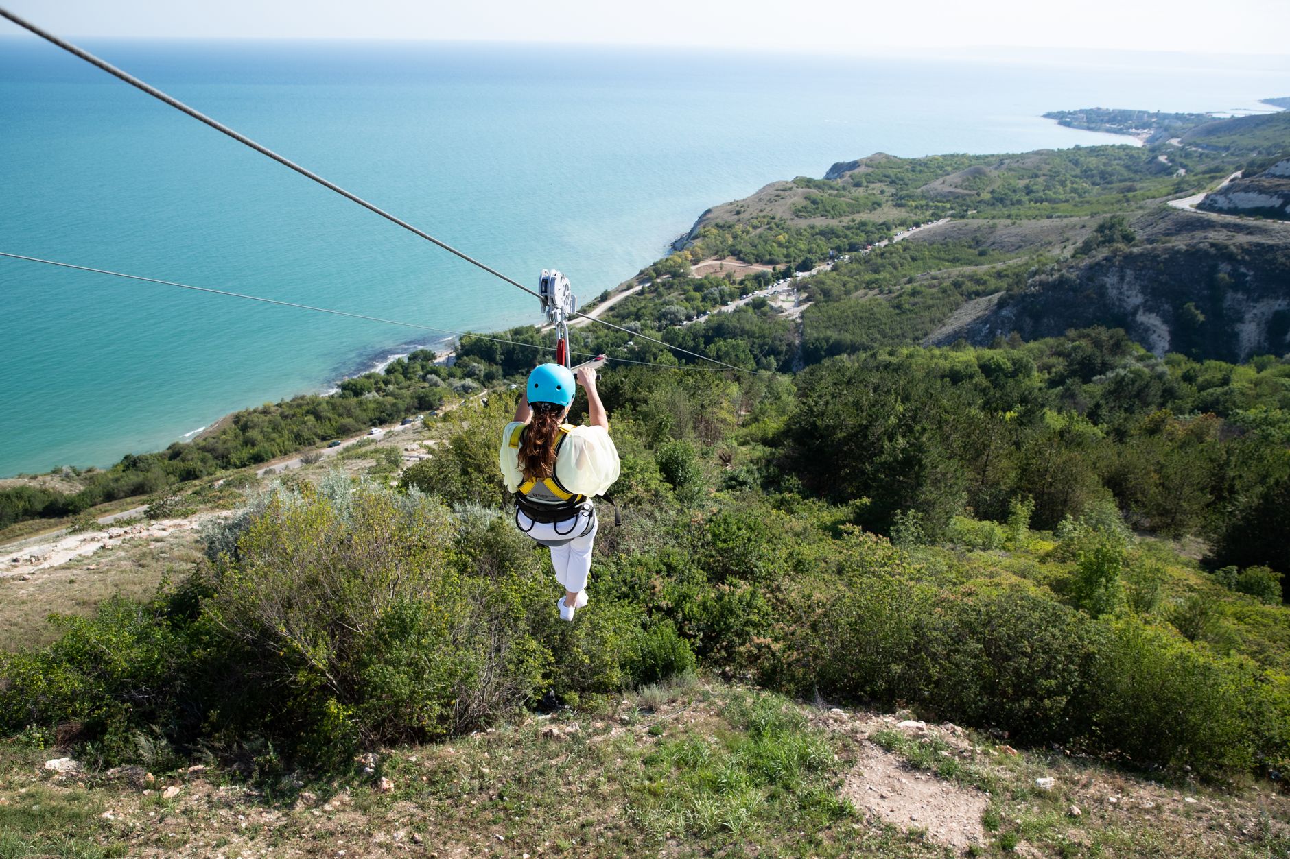 woman riding on a zip line
